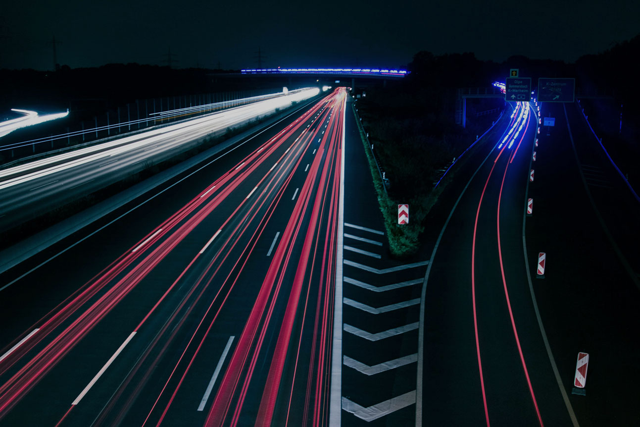 Cars driving on a highway during the night turning data into currency through MapMetrics app